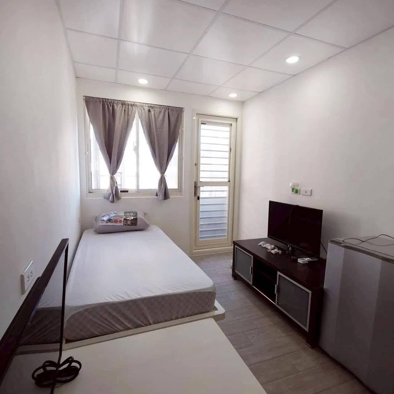 Room with a single bed, window and door to the balcony
